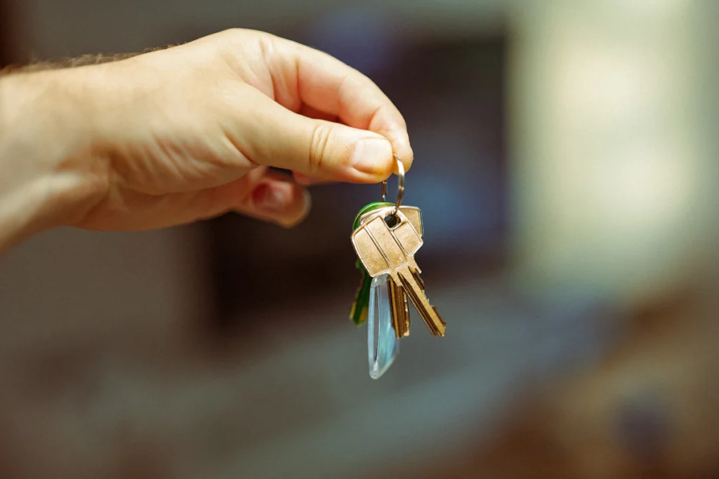Real estate agent handing over keys to a new investment property Real estate agent handing over keys to a new investment property